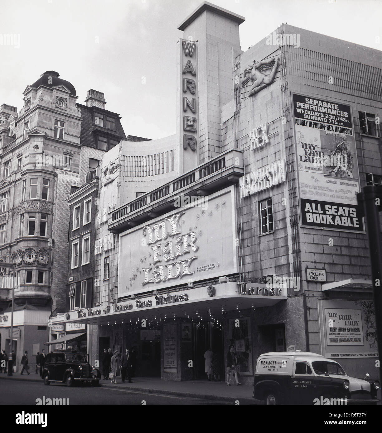 1964, the film 'My fair Lady' by Warner Bros., staring Audrey Hepburn and Rex Harrison being shown at the Warner Cinema, Leicester Court, Westminster, London, WC2. The american musical film was adapted from the famous Lerner and Loewe stage musical which itself was based on the 1913 stage play 'Pygmalion' by George Bernard Shaw. It was the estimated to be the most expensive film shot in the US up to that time, with a budget of $17 million. Stock Photo