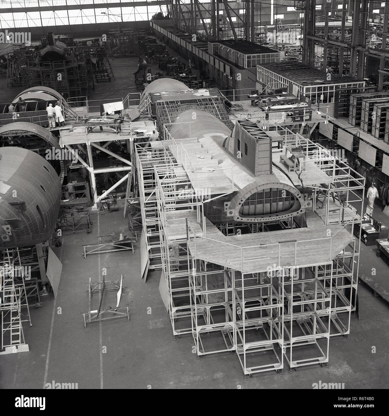 1950s, historical, aviation manufacturing... inside an aerospace hanger, aircraft being assembled. Stock Photo