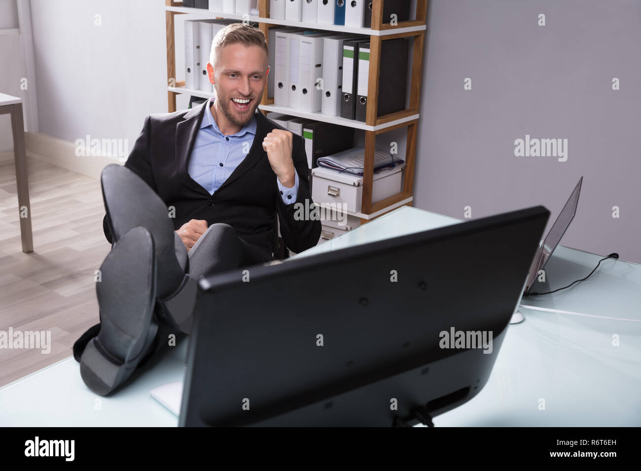Excited Businessman Looking At Computer Stock Photo
