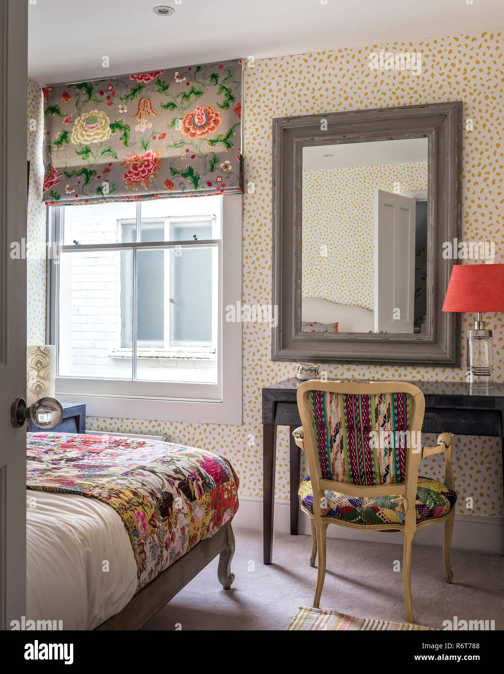 Vintage fabrics and upcycled chair in bedroom of  Richmond home Stock Photo