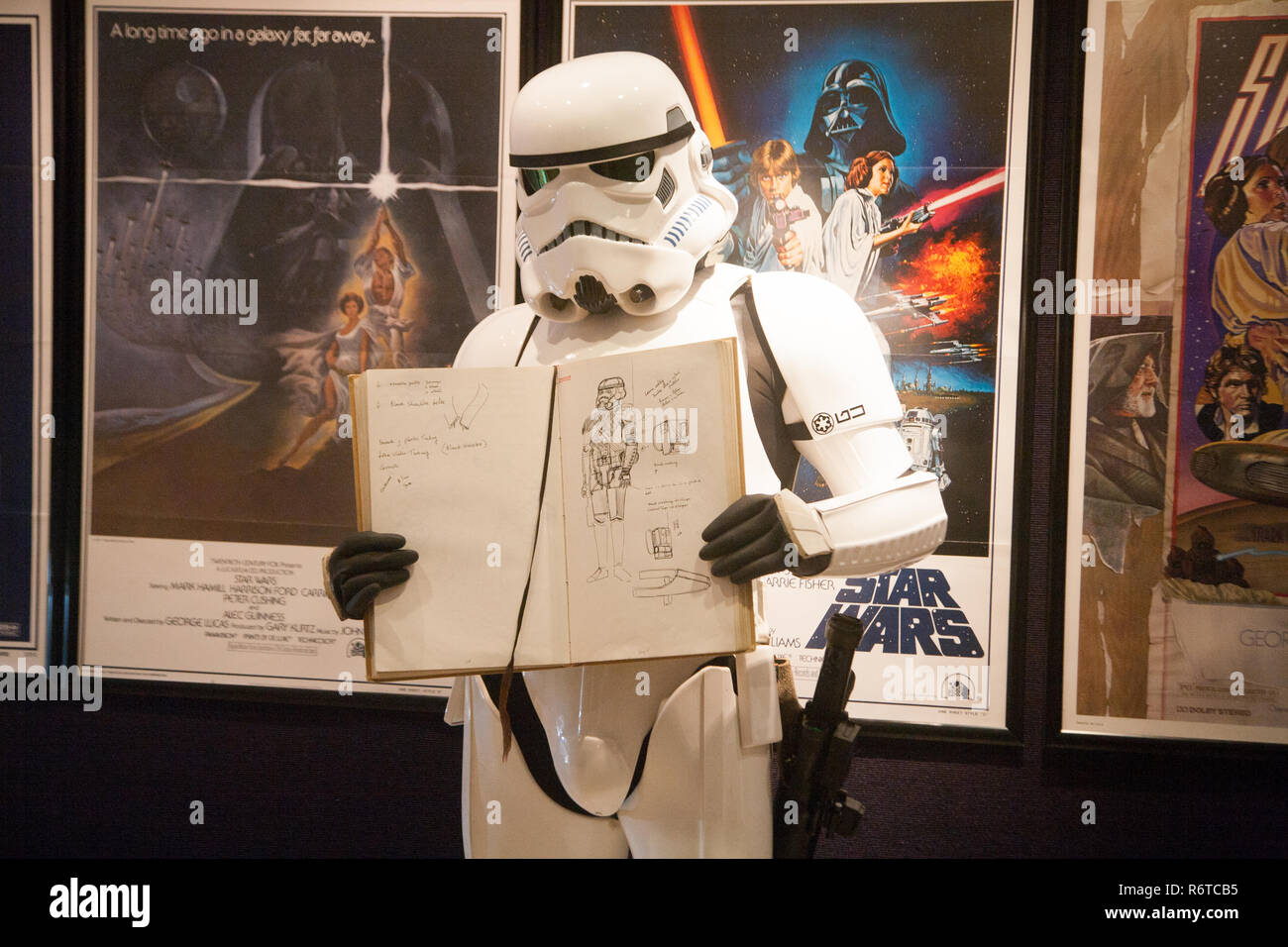 London UK. 6th December 2018. A Stormtrooper holds the original Star Wars sketchbook drawings which was designed  by British costume designer and Oscar winner Tom Mollo which will be auctioned at Bonhams Credit: amer ghazzal/Alamy Live News Stock Photo