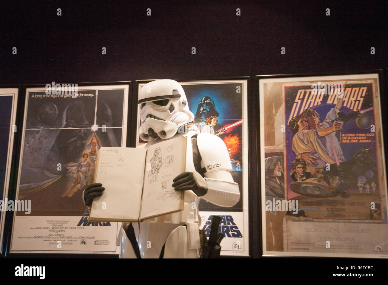 London UK. 6th December 2018. A Stormtrooper holds the original Star Wars sketchbook drawings which was designed  by British costume designer and Oscar winner Tom Mollo which will be auctioned at Bonhams Credit: amer ghazzal/Alamy Live News Stock Photo