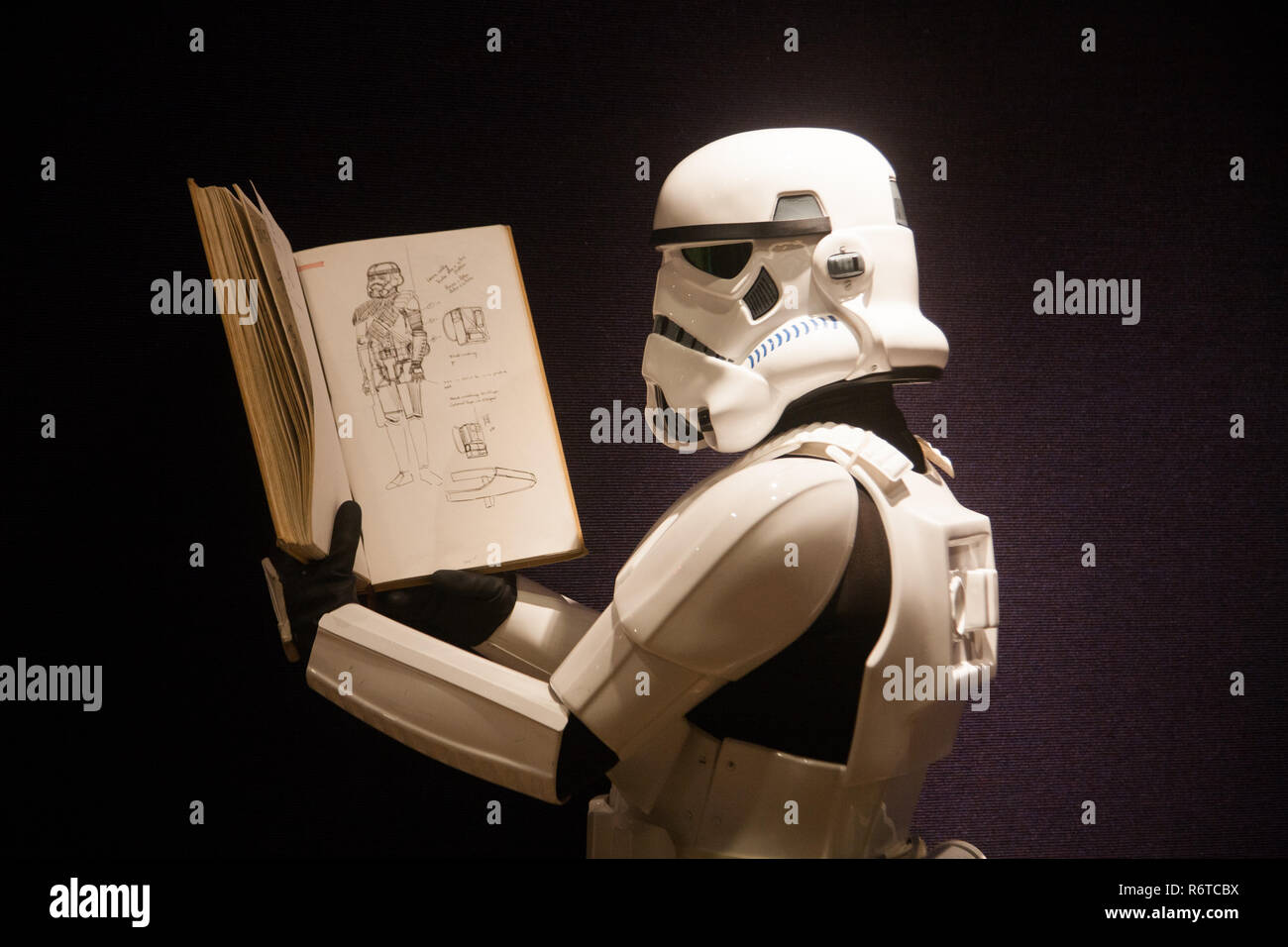 London UK. 6th December 2018. A Stormtrooper holds the original Star Wars sketchbook drawings which was designed  by British costume designer and Oscar winner Tom Mollo which will be auctioned at Bonhams. The book is estimated at £100,000-150,000 Credit: amer ghazzal/Alamy Live News Stock Photo