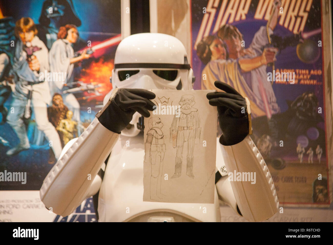 London UK. 6th December 2018. A Stormtrooper holds the original Star Wars sketchbook drawings which was designed  by British costume designer and Oscar winner Tom Mollo which will be auctioned at Bonhams. The book is estimated at £100,000-150,000 Credit: amer ghazzal/Alamy Live News Stock Photo