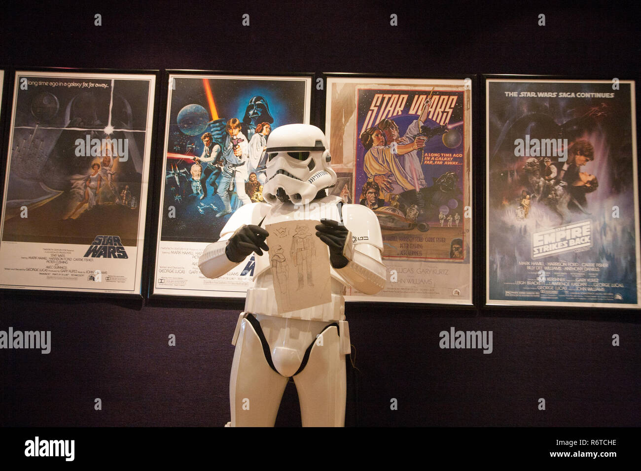 London UK. 6th December 2018. A Stormtrooper holds the original Star Wars sketchbook drawings which was designed  by British costume designer and Oscar winner Tom Mollo which will be auctioned at Bonhams. The book is estimated at £100,000-150,000 Credit: amer ghazzal/Alamy Live News Stock Photo