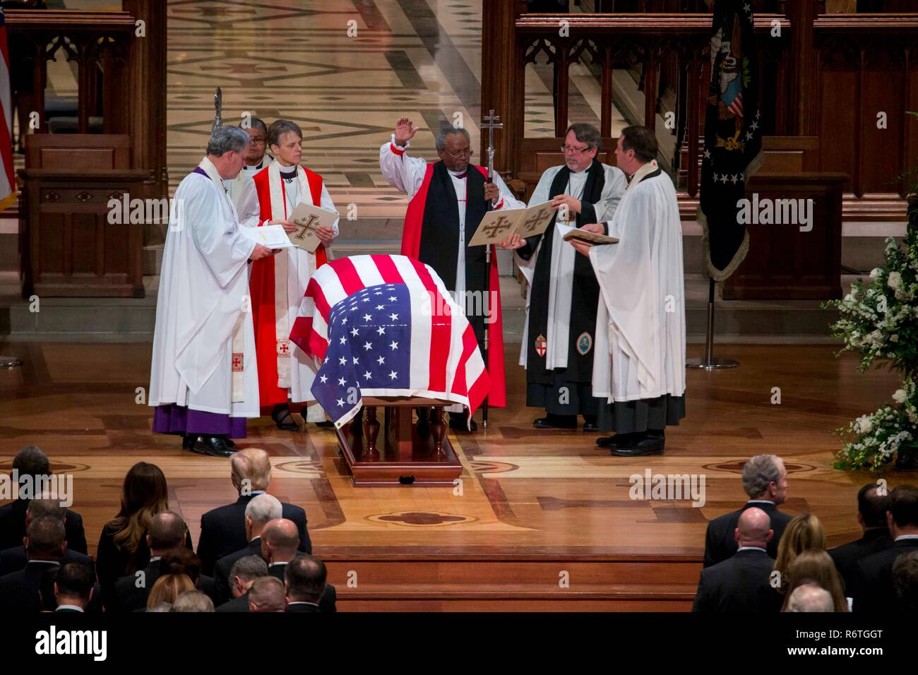 Washington DC, USA. 5th December, 2018. Presiding Bishop Michael Curry, center, and members of the Episcopal clergy perform the funeral rites over the flag draped casket of former U.S President George H.W. Bush during the State Funeral at the National Cathedral December 5, 2018 in Washington, DC. Bush, the 41st President, died in his Houston home at age 94. Credit: Planetpix/Alamy Live News Stock Photo