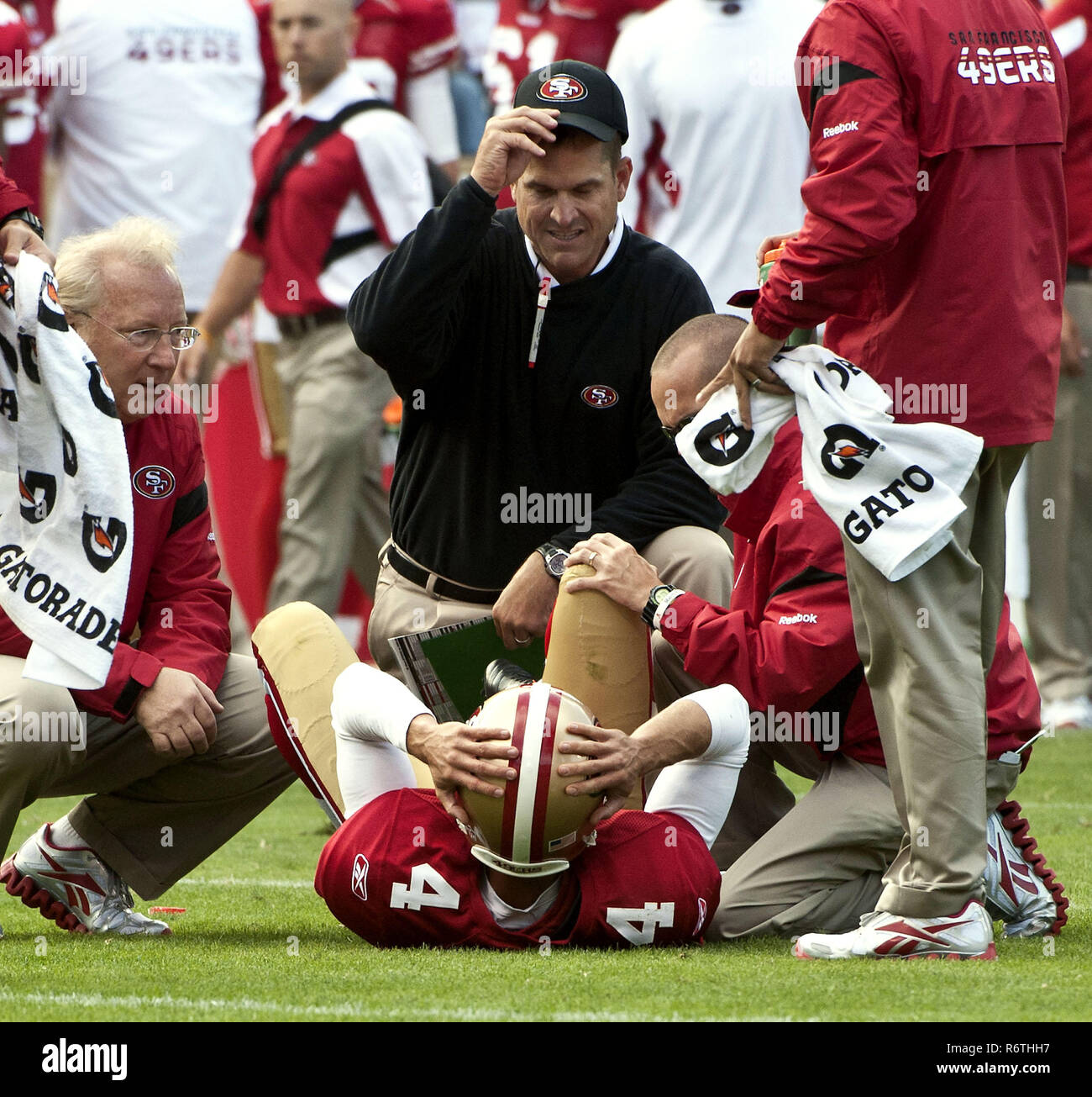 San Francisco, California, USA. 20th Aug, 2011. San Francisco Head Coach Jim Harbaugh checks on San Francisco 49ers punter Andy Lee (4) after he was injured on Sunday, August 20, 2011 at Candlestick Park, San Francisco, California. The 49ers defeated the Raiders in preseason game 17-3. Credit: Al Golub/ZUMA Wire/Alamy Live News Stock Photo