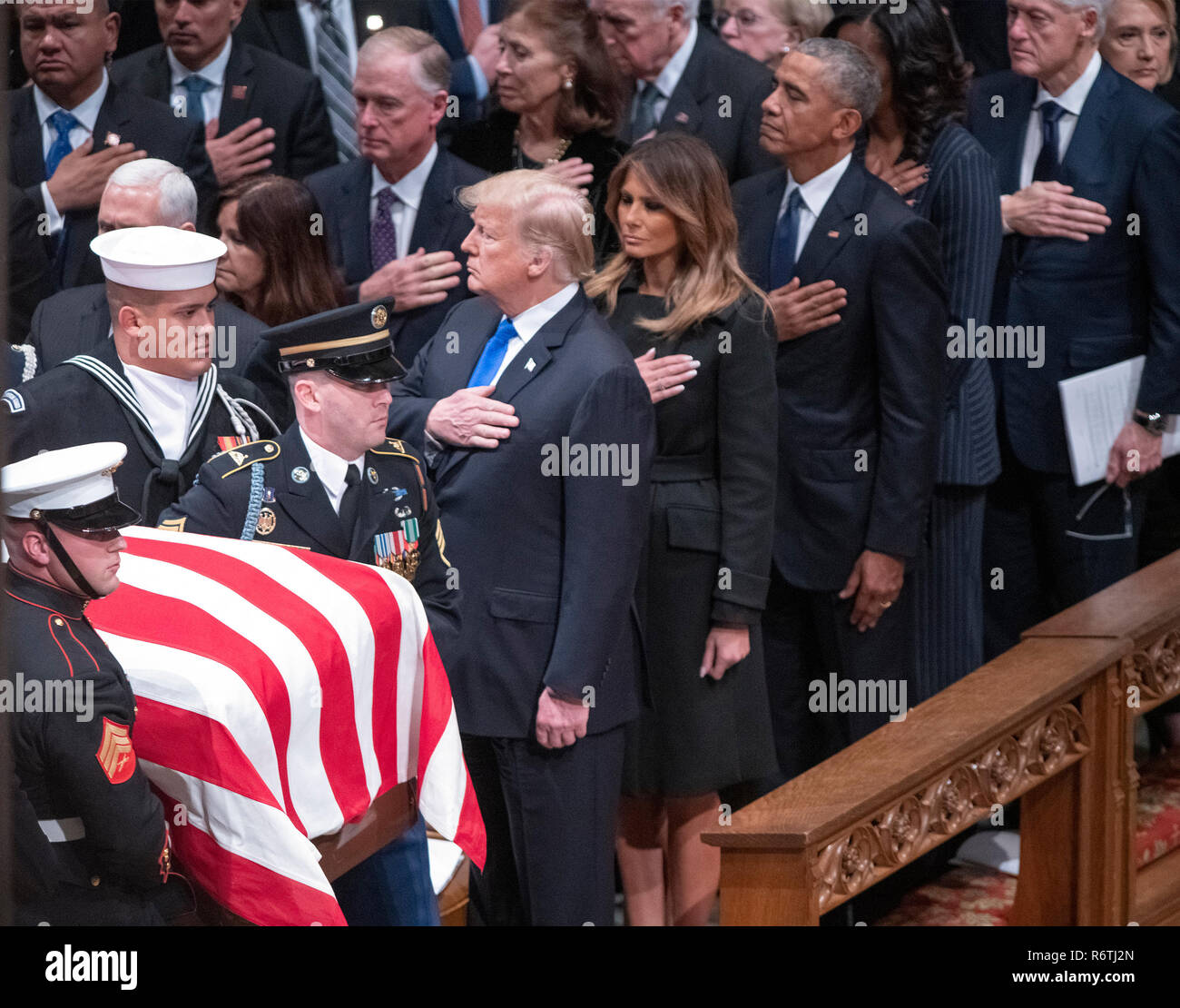 Dignitaries pay their respects as the casket containing the remains of the late former United States President George H.W. Bush at the National funeral service in his honor at the Washington National Cathedral in Washington, DC on Wednesday, December 5, 2018. Front row: United States President Donald J. Trump, first lady Melania Trump, former US President Barack Obama, and former US President Bill Clinton. Second row: former US Vice President Dan Quayle and Marilyn Quayle. Credit: Ron Sachs/CNP (RESTRICTION: NO New York or New Jersey Newspapers or newspapers within a 75 mile radius of New Stock Photo