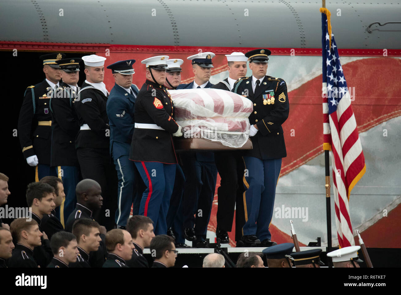 Military honor guard pallbearers carry the casket of former President George H.W. Bush from a funeral train from Houston after its arrival at Texas A&M University for burial at the George Bush Library on campus. Stock Photo