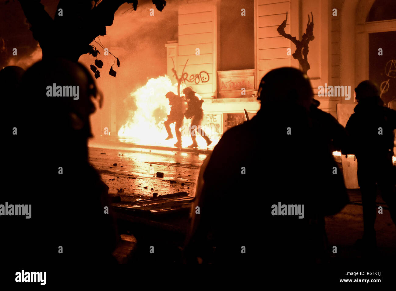 A fire is seen after protesters throw petrol bomb toward the riot Police  during a rally marking the 10th anniversary of the killing of teenager  Alexis Grigoropoulos by a Greek police officer