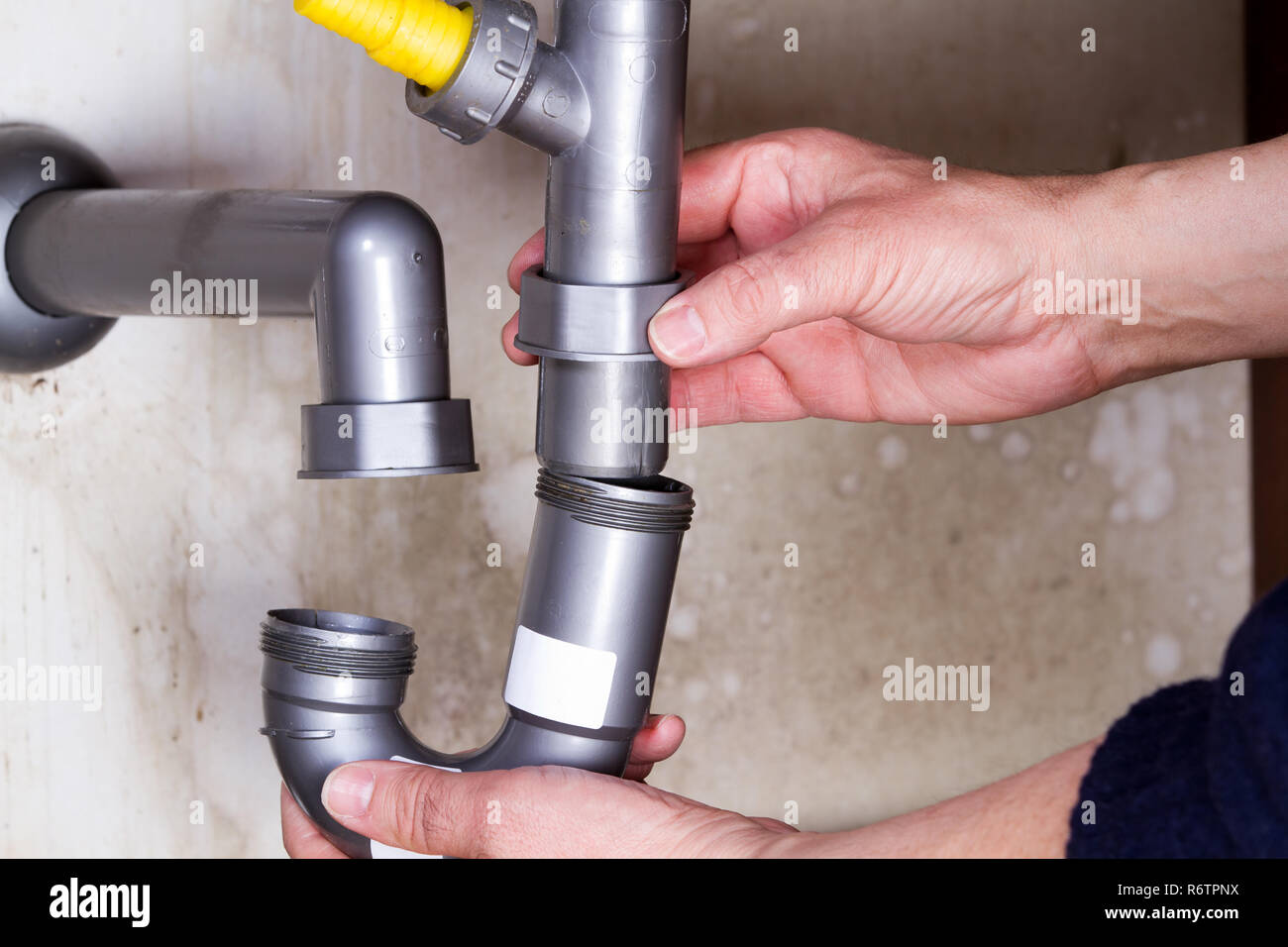 plumber at work to fix a sink Stock Photo Alamy