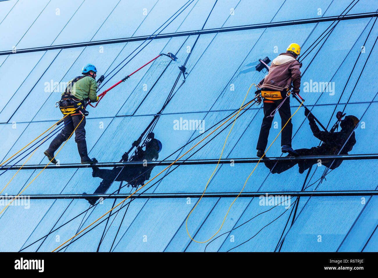 window cleaners at work on a glass facade, Czech Republic Stock Photo