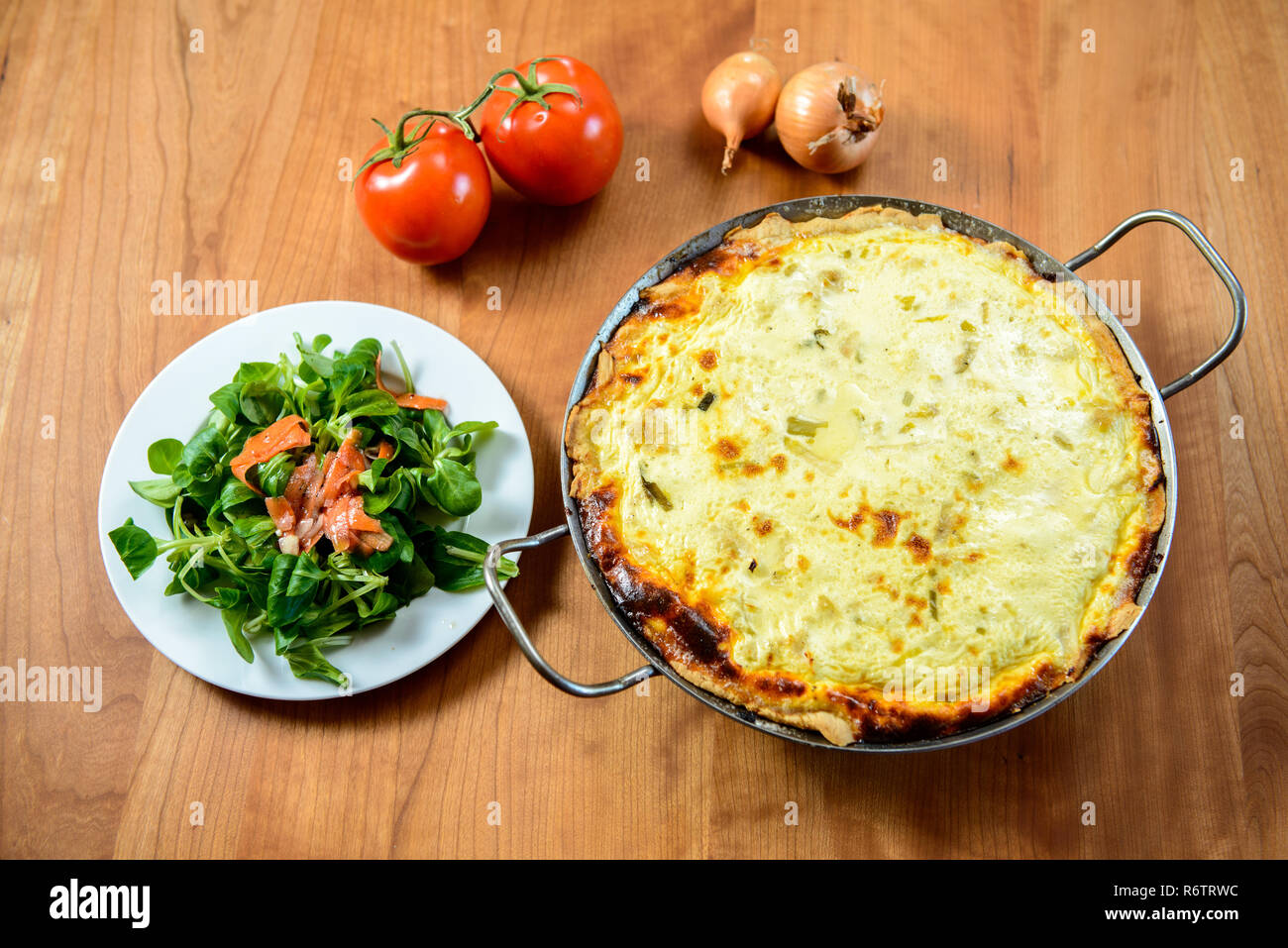baked quiche with field salad Stock Photo Alamy