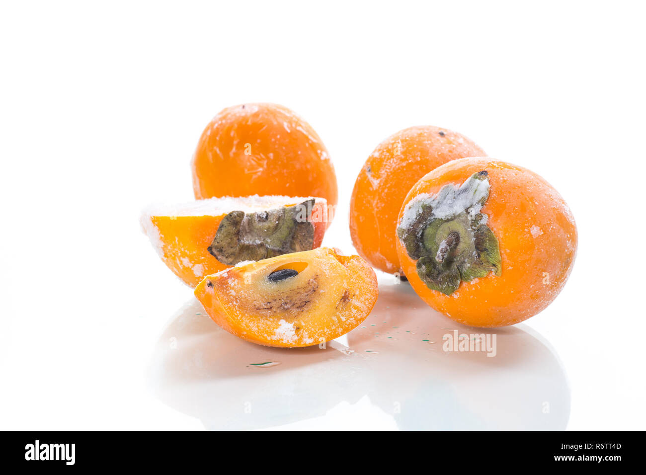 frozen ripe persimmon in ice isolated on white Stock Photo - Alamy