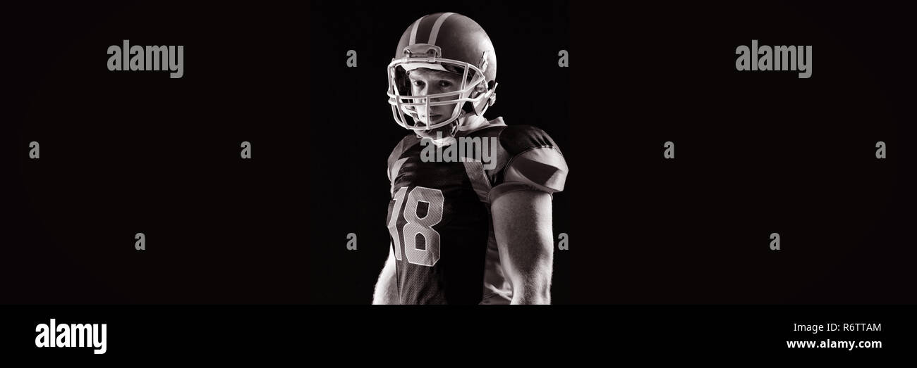 Portrait of American football player in helmet Stock Photo