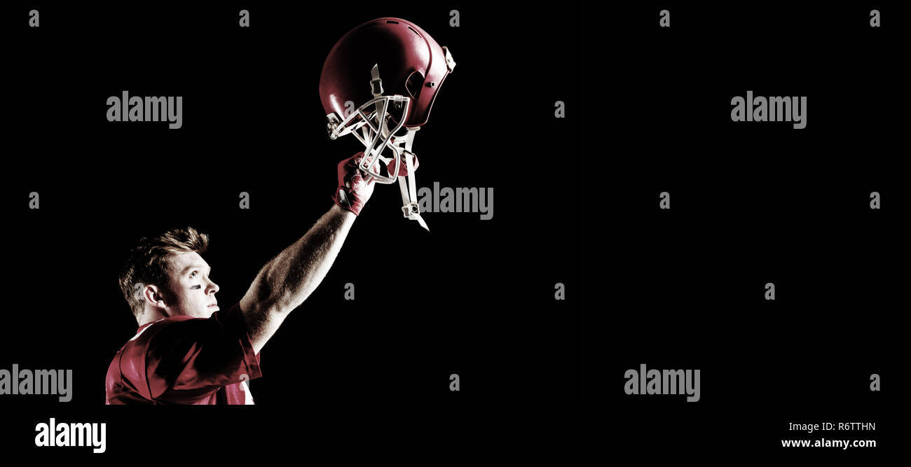 Side view of American football player cheering with arm up Stock Photo