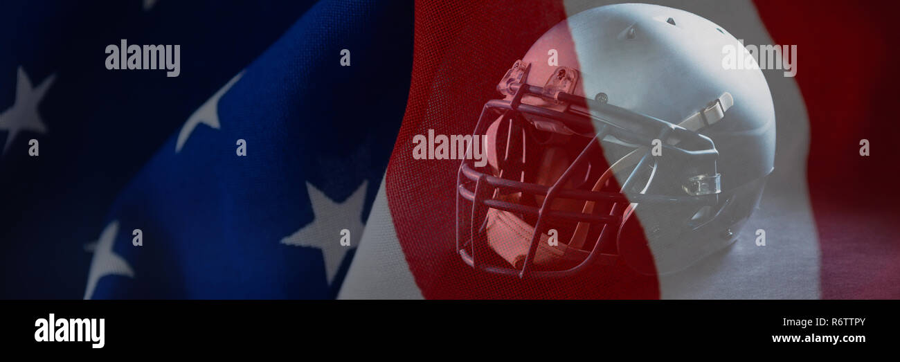 Close up of sports helmet against crumbled american flag Stock Photo