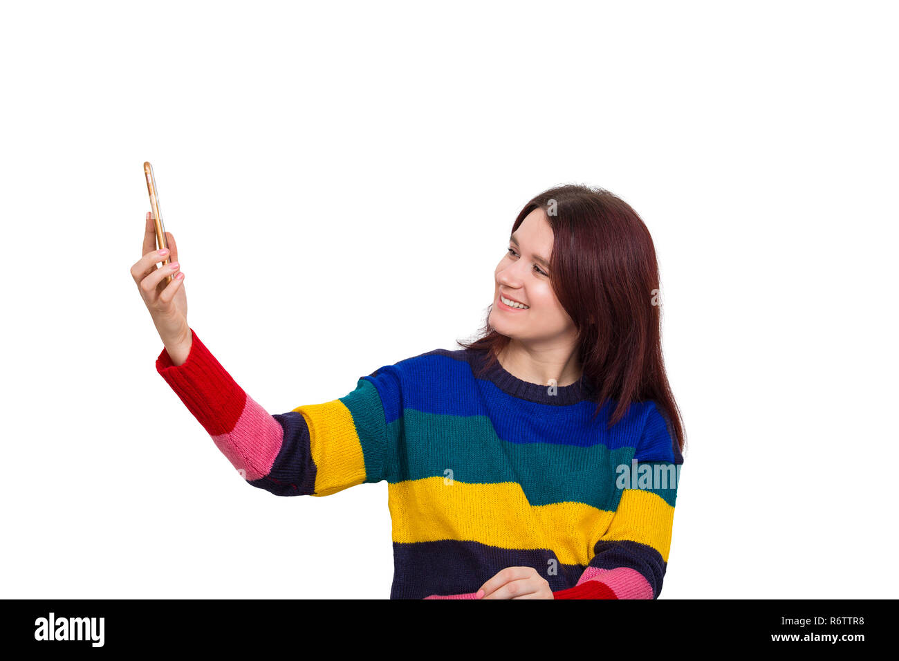 Happy young woman taking a selfie using her mobile phone isolated over ...