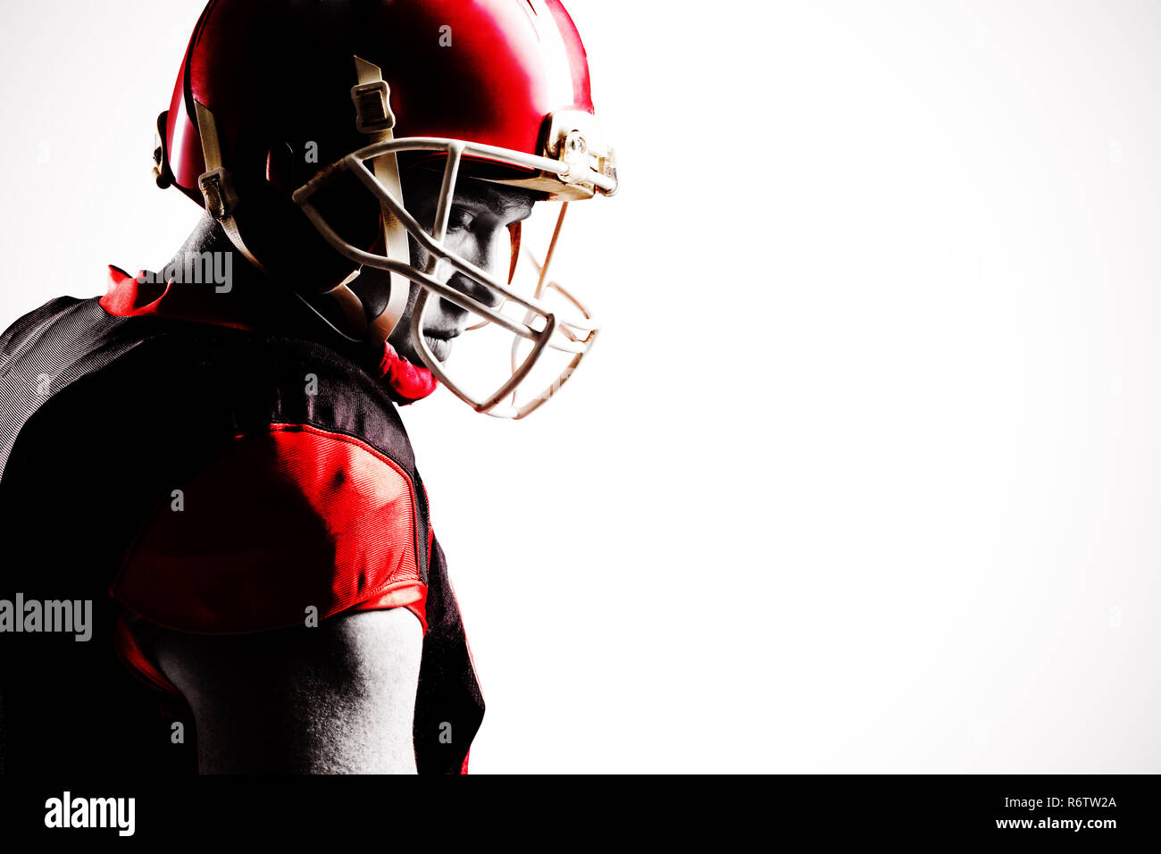 Young American football player standing in helmet Stock Photo