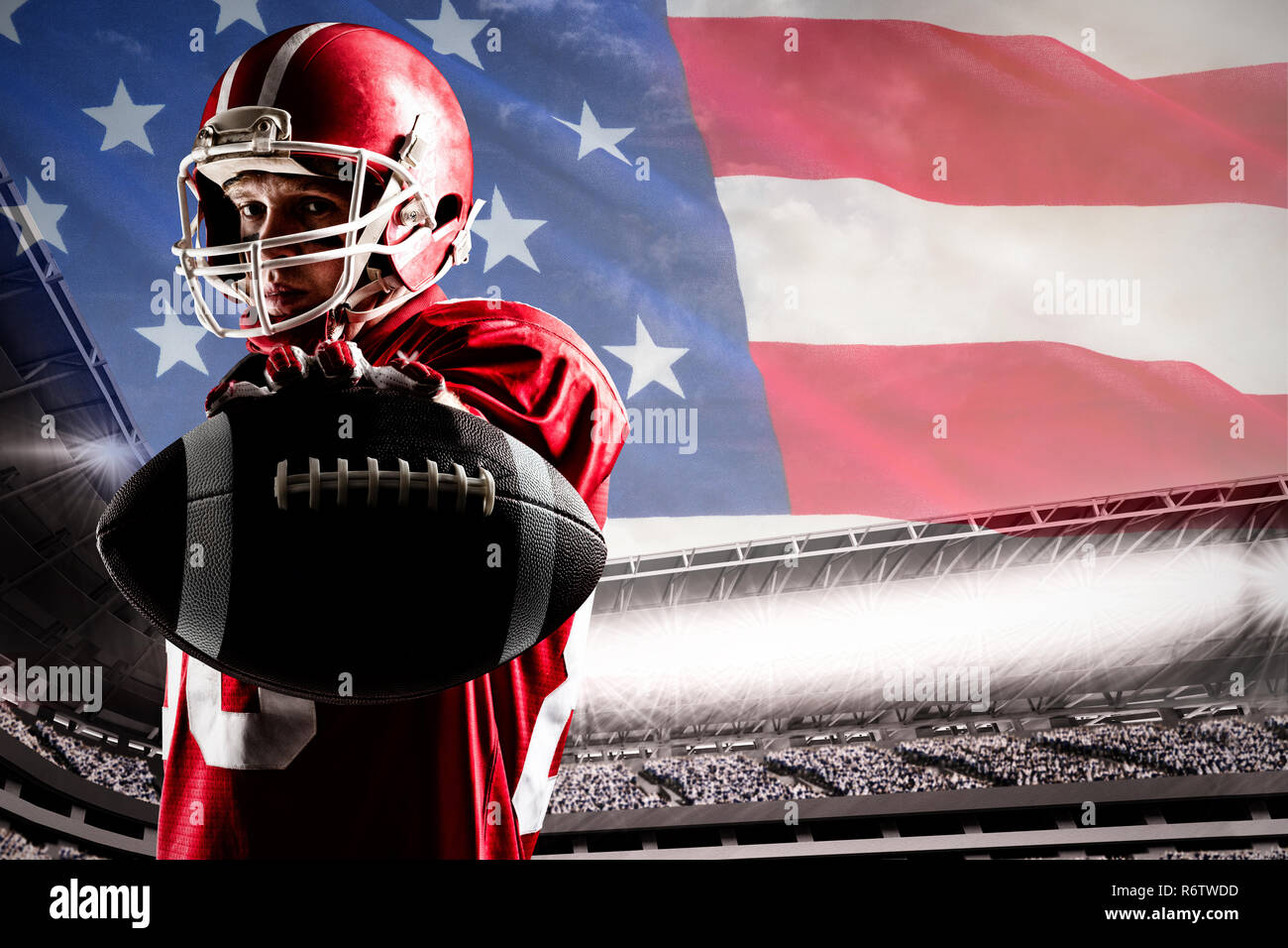 American football player standing in rugby helmet and holding rugby