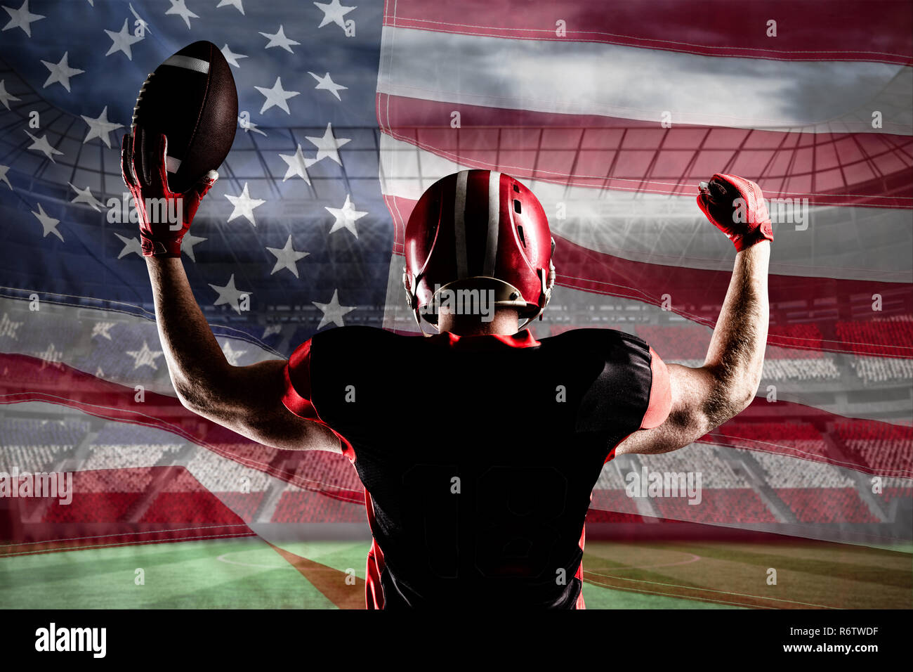 American football player standing with helmet holding football in