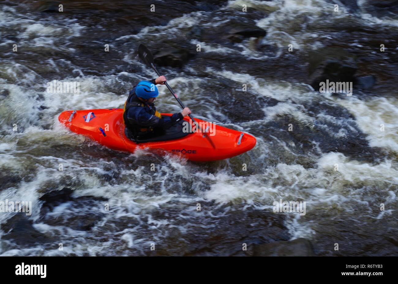 Man in Red Kayak Going Down the East Lyn River. Exmoor National Park, North Devon, UK Stock