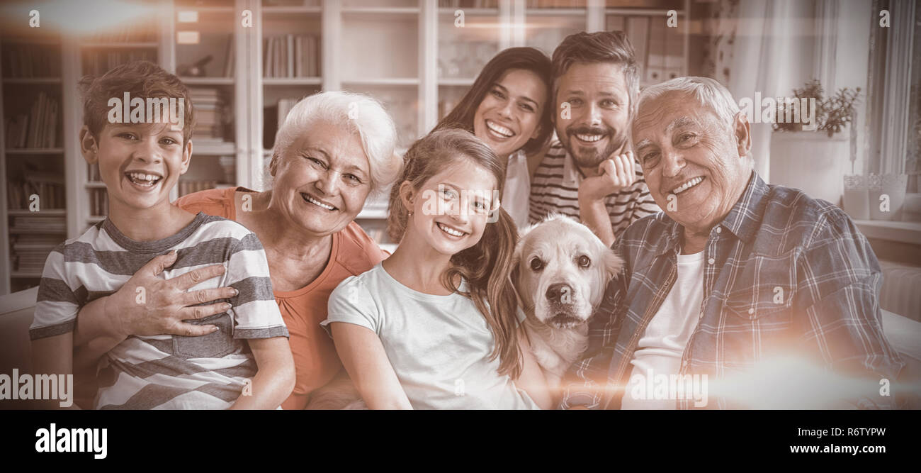 Portrait of happy multi generation family sitting on sofa in living ...