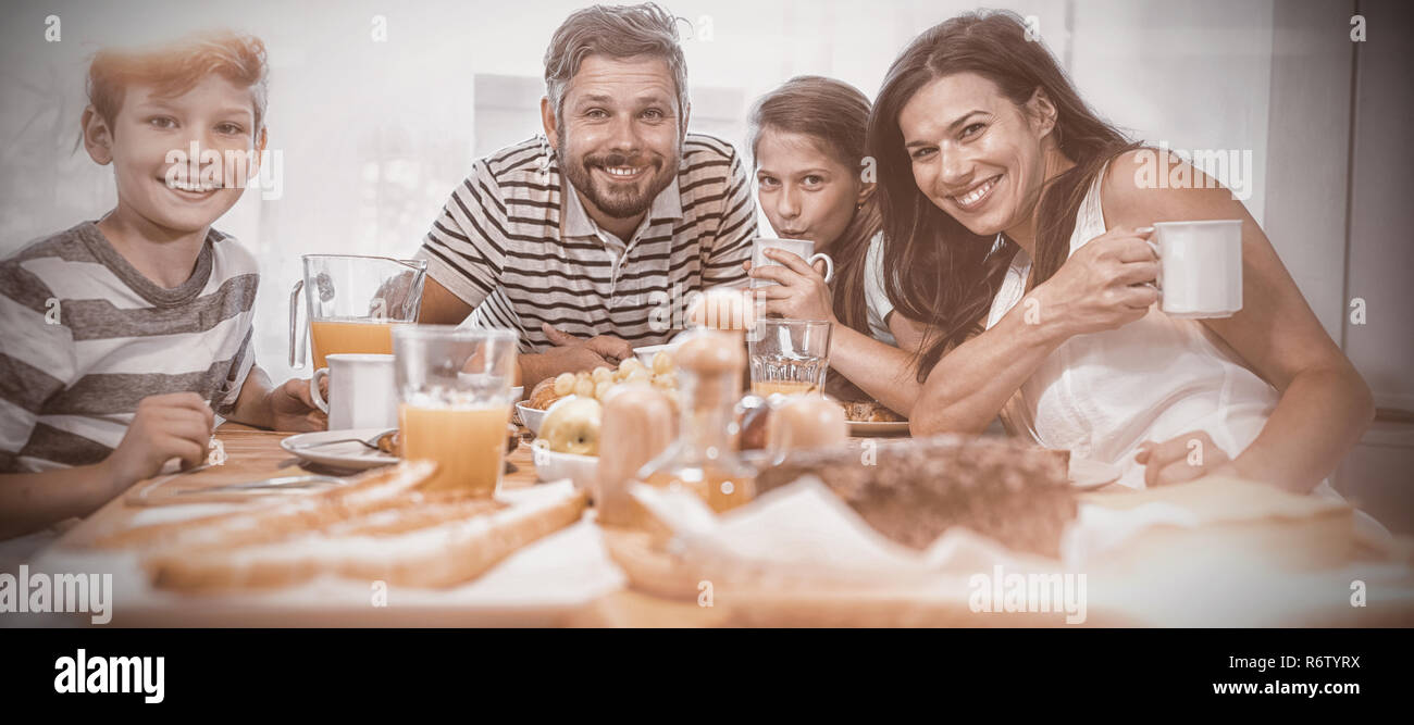 Portrait of happy family having breakfast together Stock Photo - Alamy