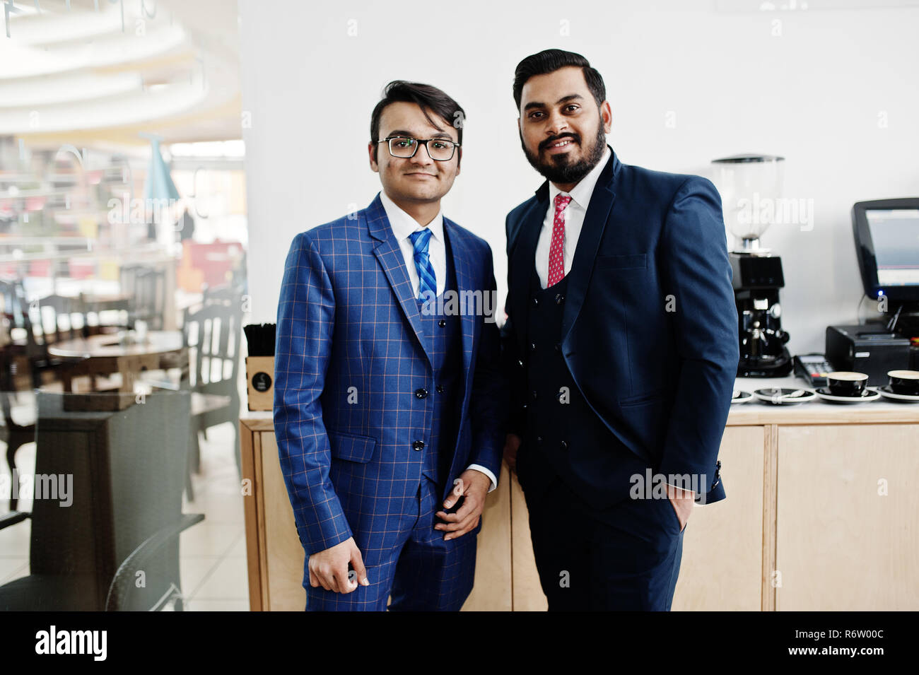 Two indian businessman in suits standing on cafe Stock Photo - Alamy