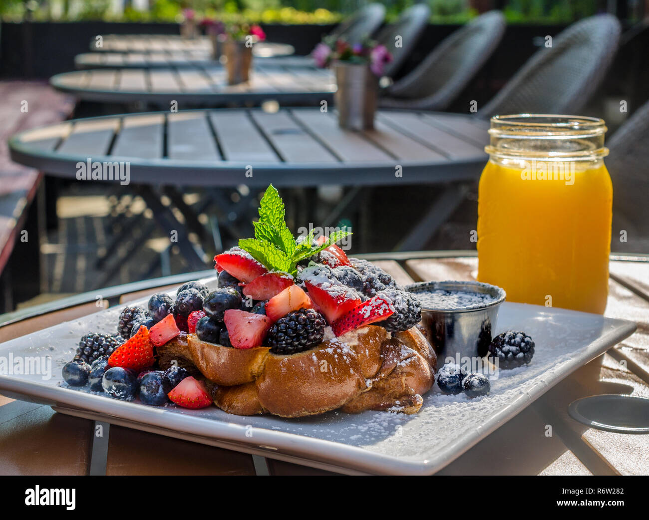 Challah French toast stuffed with honeyed ricotta, topped with fruit, powdered sugar, and maple syrup at Sun in My Belly Cafe in Atlanta, Georgia. Stock Photo