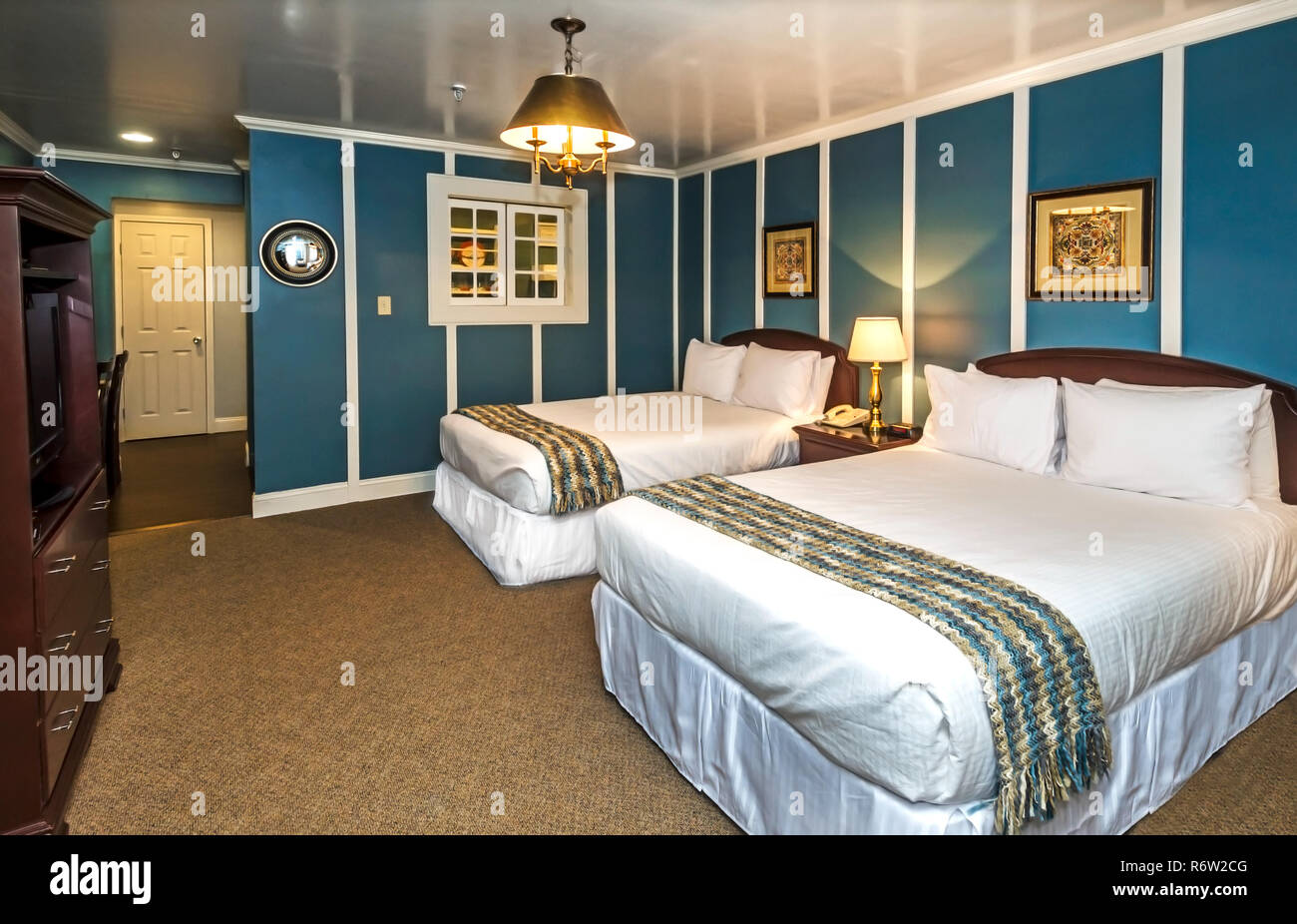 Blue walls greet guests in one of the remodeled rooms at University Inn