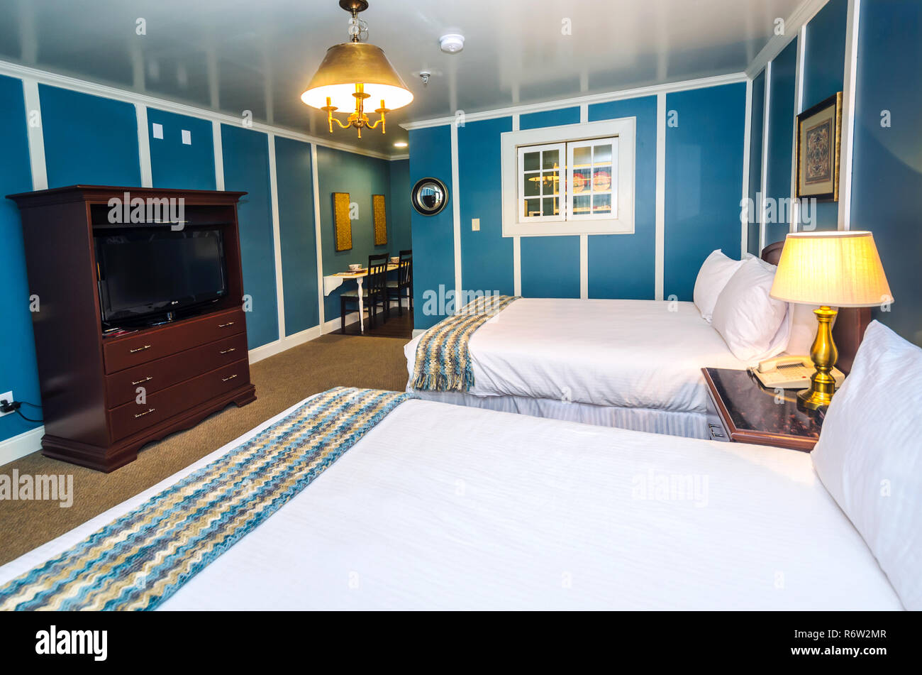 Blue Walls Greet Guests In One Of The Remodeled Rooms At