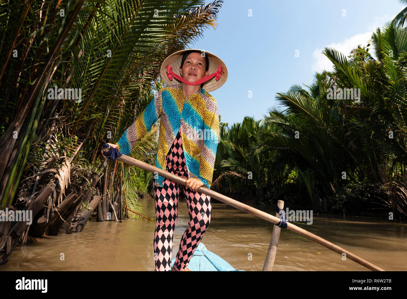 Vietnamese woman rowing  passengers on  'punt like boat'  on a  River Mekong  Delta tour - My Tho village, Bao Dinh Channel, Mekong Delta,Vietnam Stock Photo