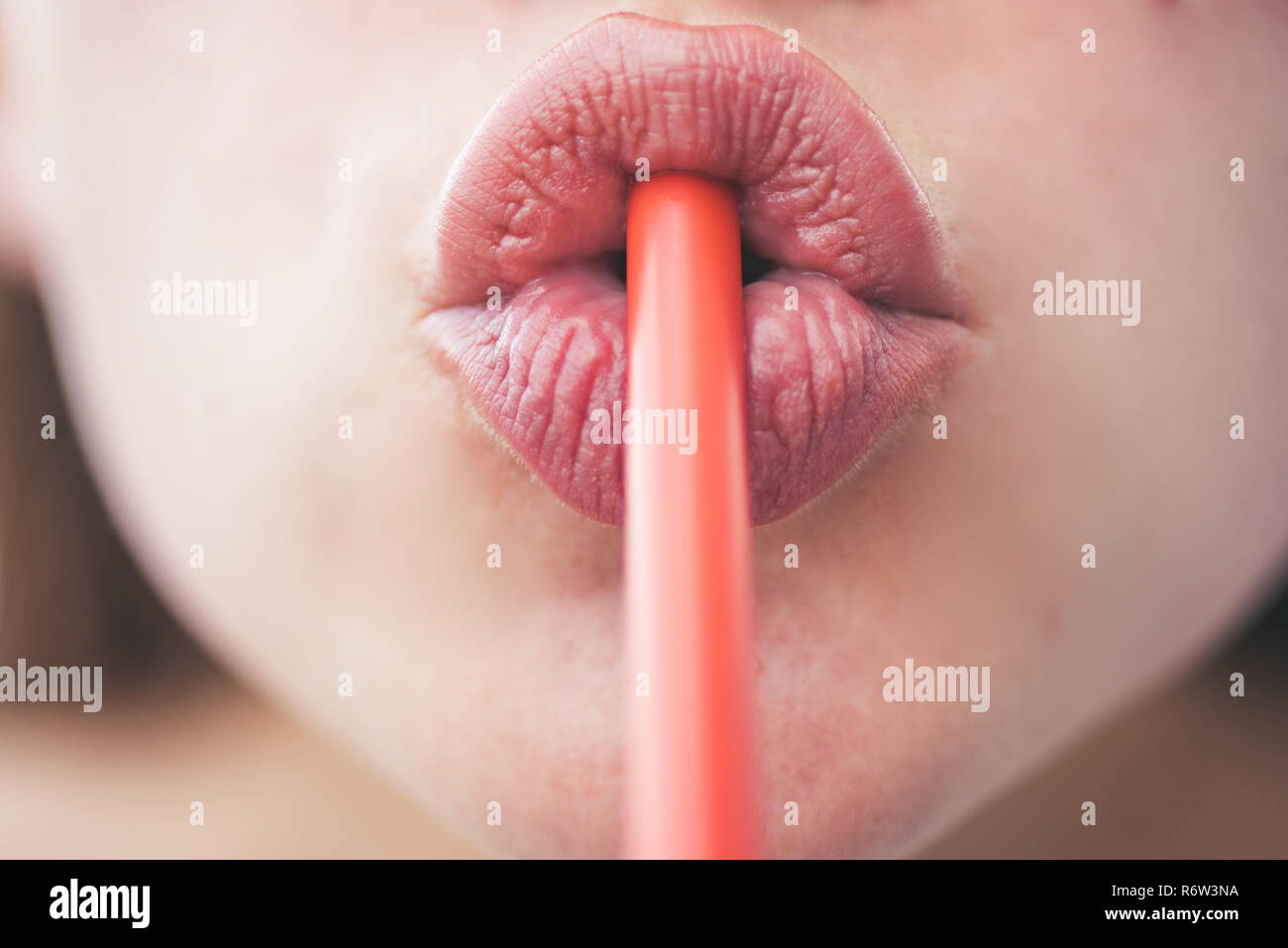 Drinking Straw Day. Sipping drink through straw. Female lips while