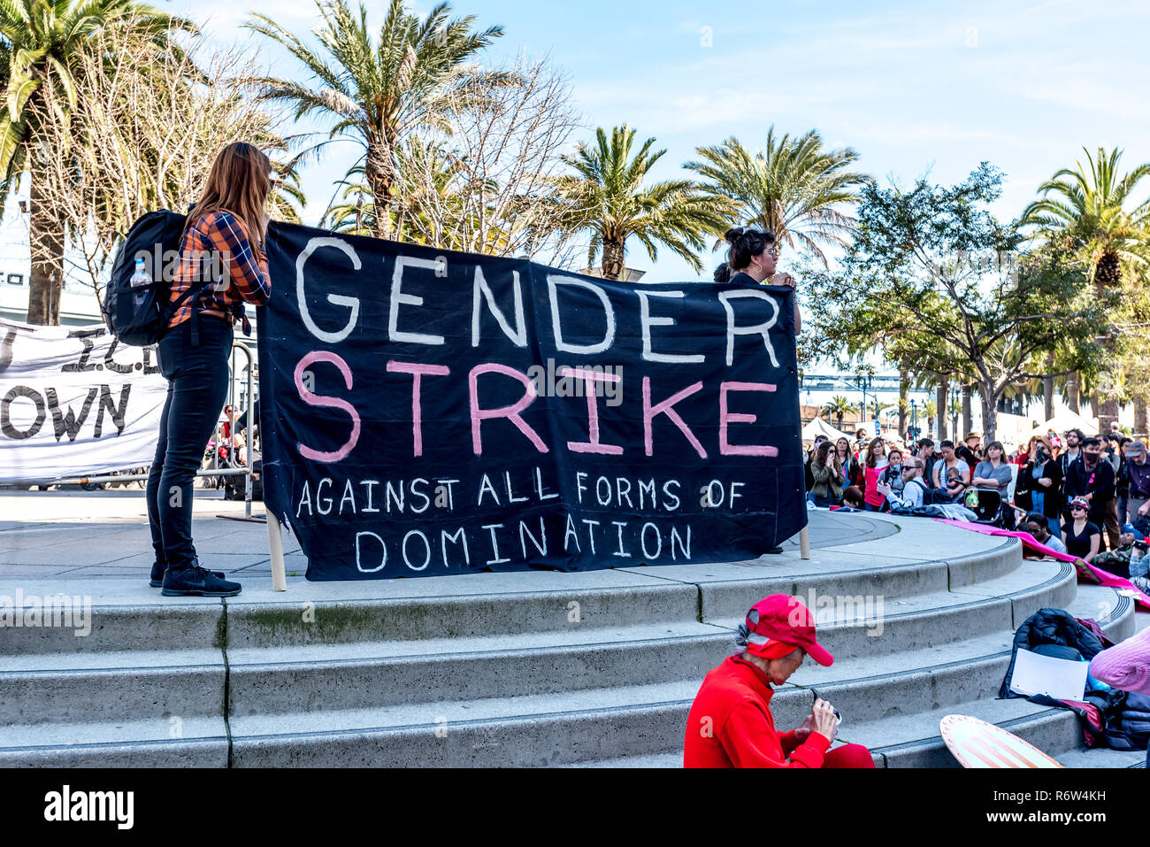 San Francisco, USA. 8th Mar, 2017.  Two women hold a large banner reading 'Gender strike against all forms of domination' at Justin Herman Plaza during the International Women's Day rally. Credit: Shelly Rivoli/Alamy Live News Stock Photo