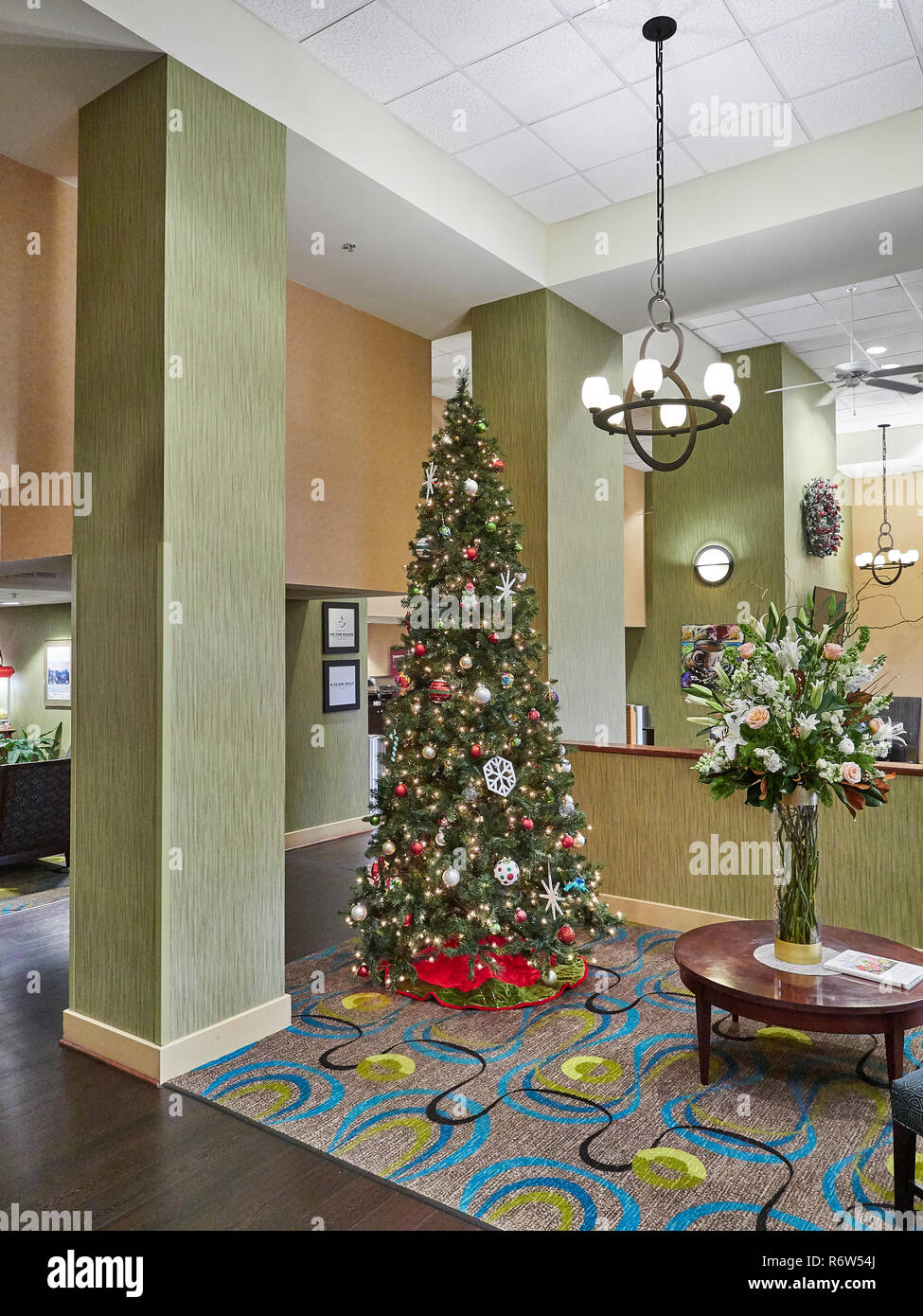 Decorated Christmas tree in the Hampton Inn hotel lobby, in Fairhope Alabama, USA. Stock Photo