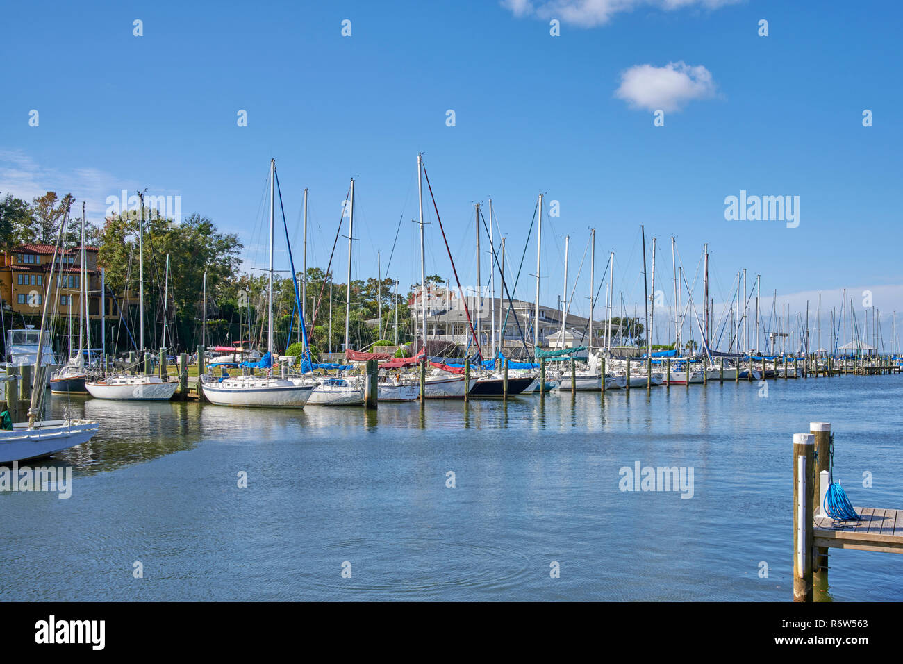 Sailboats tied up and lined up in boat slips at Fly Creek Marina on Mobile Bay, in Fairhope Alabama, USA. Stock Photo