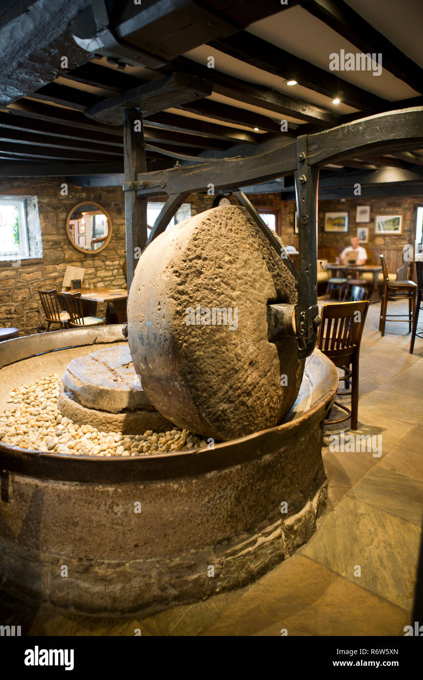 stone flour mill on display in a public house Stock Photo Alamy