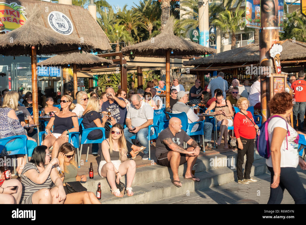 Benidorm, Costa Blanca, Spain. Drinkers enjoy high winter temperatures at the Tiki Beach bar on Levante beach has now been refurbished and reopened Stock Photo