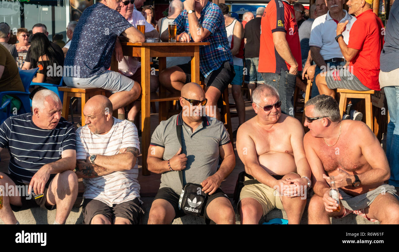 Benidorm, Costa Blanca, Spain. Drinkers enjoy high winter temperatures at the Tiki Beach bar on Levante beach has now been refurbished and reopened Stock Photo