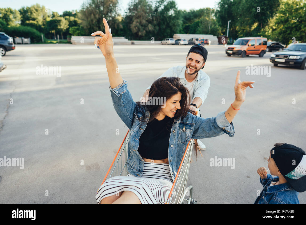 Dad carries mom in a trolley with a supermarket Stock Photo Alamy