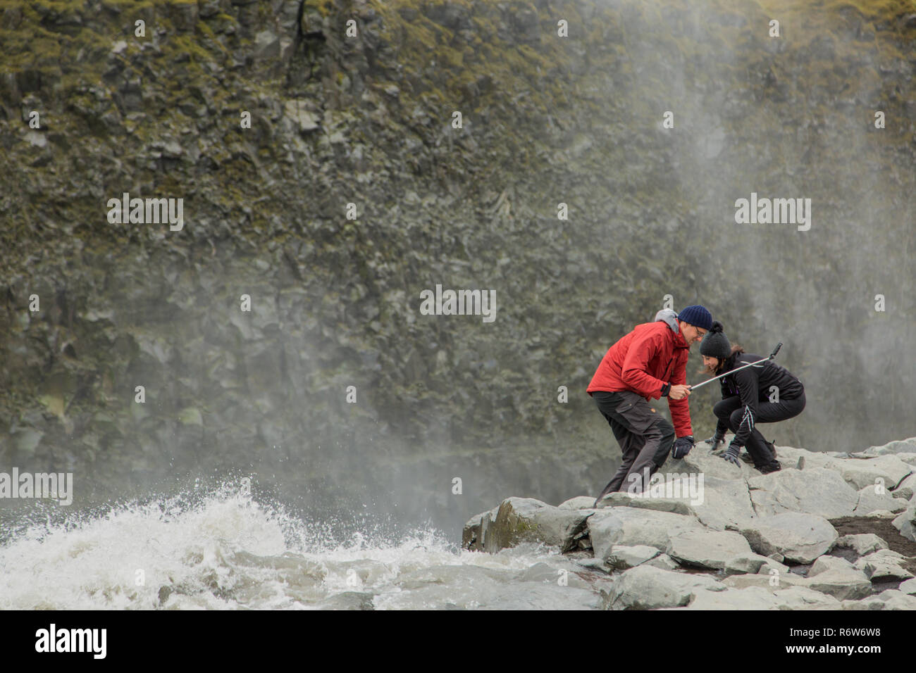 Tourists get dangerously close to the edge of the waterfall Dettifoss