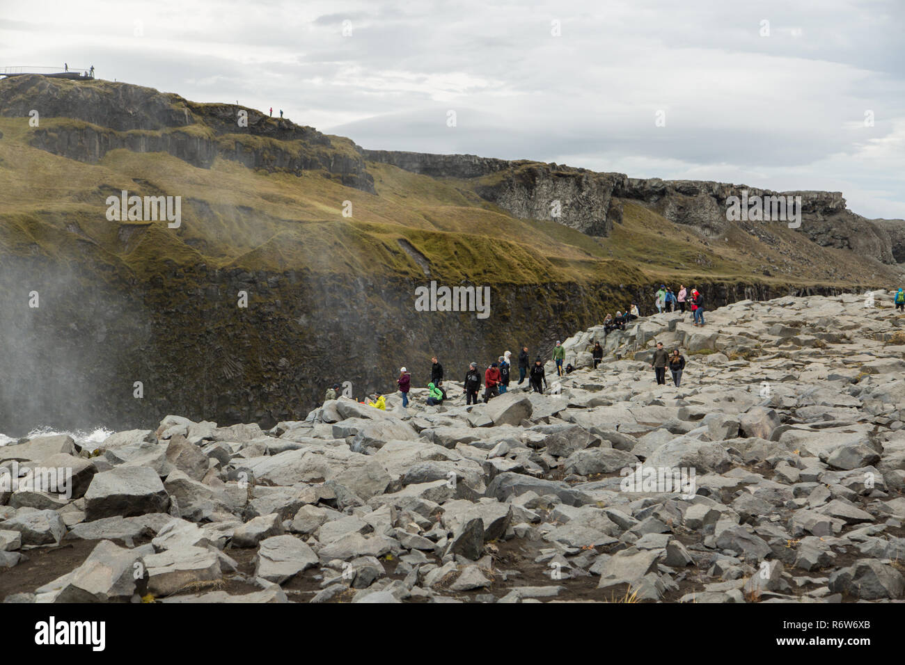 Tourists get dangerously close to the edge of the waterfall Dettifoss