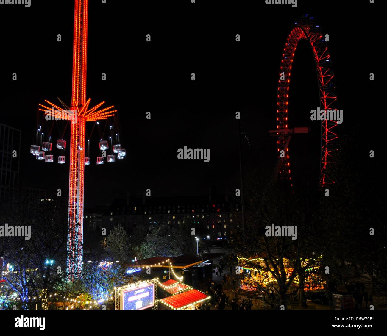 Winter Starflyer fairground ride and Christmas Market at Southbank Winter Festival (l) and London Eye (r), Lambeth, London, UK. Stock Photo