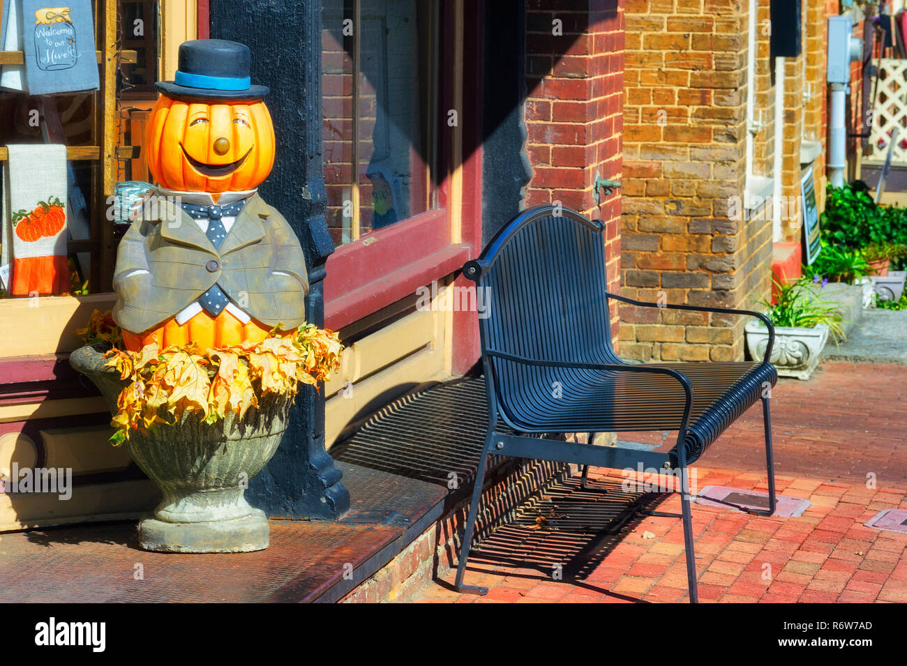 Jonesborough,Tennessee,USA - October 24th, 2018: A happy jack-o-lantern statue adorns the steps leading into a store on main street. Stock Photo