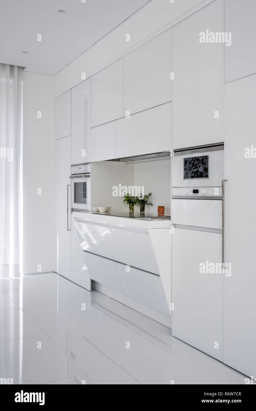 Recessed induction hob in minimalist kitchen of new build villa, Quinta do Lago Stock Photo