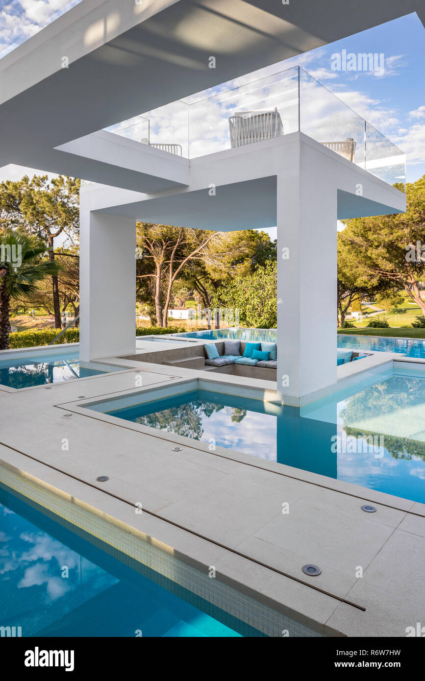 Sunken seating area among pools of water and shaded structures of new build villa, Quinta do Lago Stock Photo
