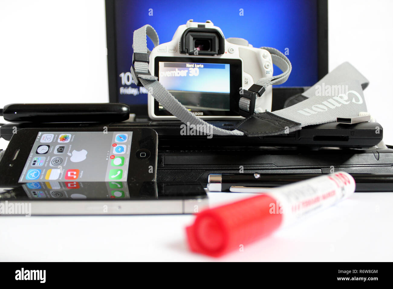 Technology set, Camera Canon 100d, laptop lenovo thinkpad, apple iphone 4s, presenter, microsoft windows, external hard drive Stock Photo