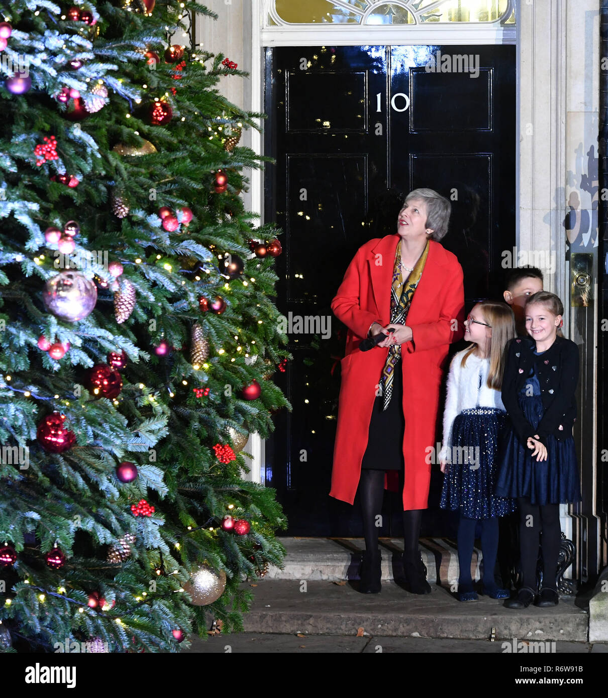 Prime Minster Theresa May, with children, switches on the lights on the