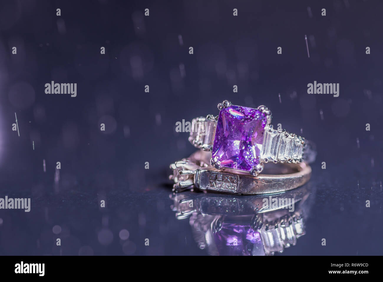 Engagement rings with water droplets on dark background Stock Photo